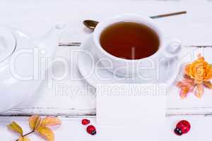 black tea in a round white cup with saucer