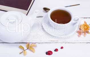 black tea in a round white cup with a saucer