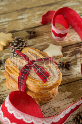 Cookies and christmas decoration on wooden plank