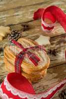 Cookies and christmas decoration on wooden plank