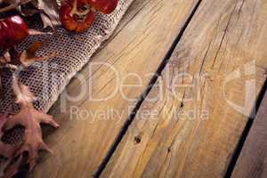 Dry leaves and mistletoe on wooden plank