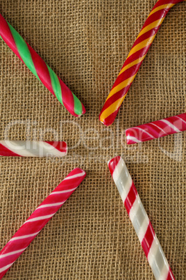 Multicolored candy canes arranged on fabric