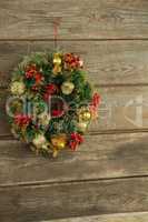 Christmas wreath against wooden background
