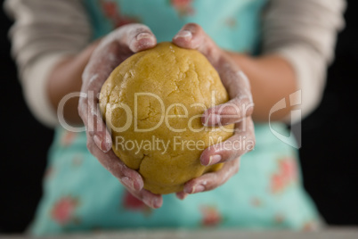 Woman holding a dough