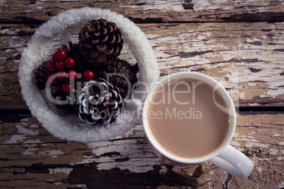 Coffee and christmas decoration on wooden plank