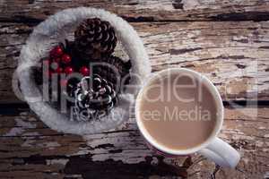 Coffee and christmas decoration on wooden plank