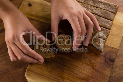 Woman arranging dough on chopping board