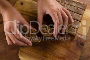 Woman arranging dough on chopping board