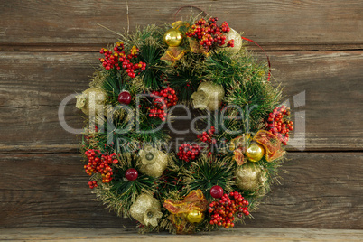 Christmas wreath against wooden background