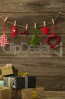 Christmas decorations hanging against wooden wall