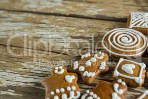 Gingerbread cookies arranged on wooden plank