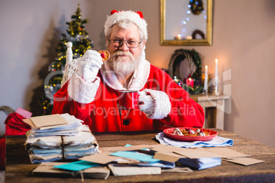 Santa Claus having a cookie with coffee