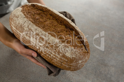 Woman holding a loaf of bread