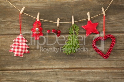 Christmas decorations hanging against wooden wall