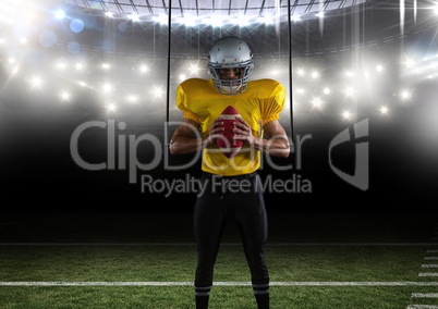 american football  player standing with the ball in his hands