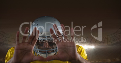 american football  player with hands in front of his face