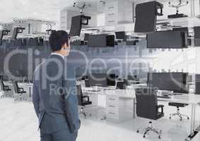 businessman standing in inverted office with skyline