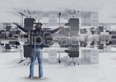 Man standing and spreading arms in inverted office