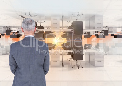 businessman standing in inverted office in clouds with flare