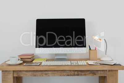 Desktop pc and various office accessories on table