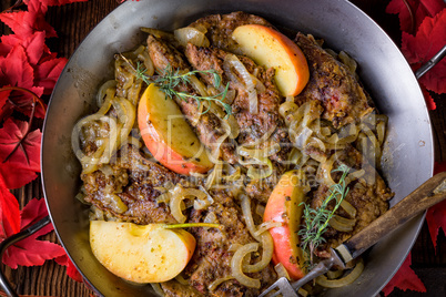 Fried liver with onion apple and herbs.