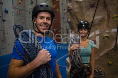 Portrait of athletes in sports helmet carrying ropes at exercise class