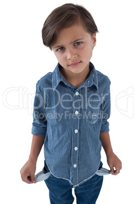 Boy standing with empty pockets against white background