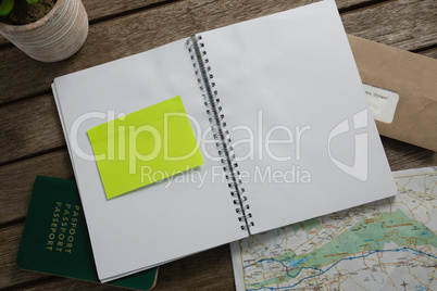 Passport, map, organizer and envelope on wooden table