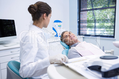 Patient discussing with dentist at medical clinic
