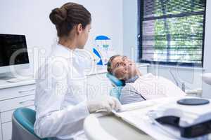 Patient discussing with dentist at medical clinic
