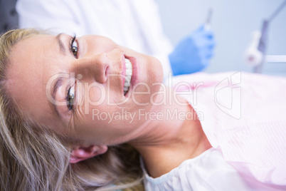 Portrait of smiling patient against dentist