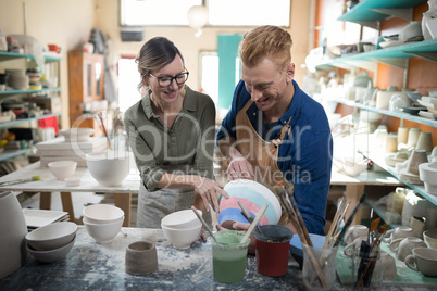 Male and female potter interacting with each other