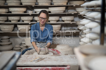 Female potter molding a clay