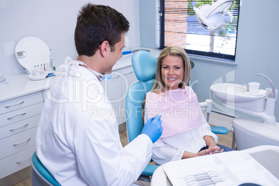 Smiling patient discussing with dentist