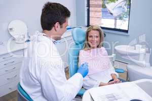 Smiling patient discussing with dentist