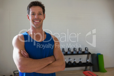 Portrait of confident athlete with arms crossed standing in gym Portrait of confident athlete with arms crossed standing in gym
