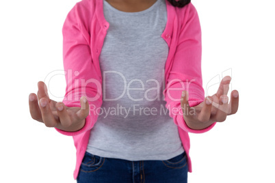 Girl pretending to hold an invisible object against white background