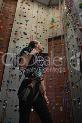 Low angle view of athlete looking up while standing in gym