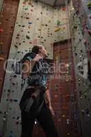 Low angle view of athlete looking up while standing in gym