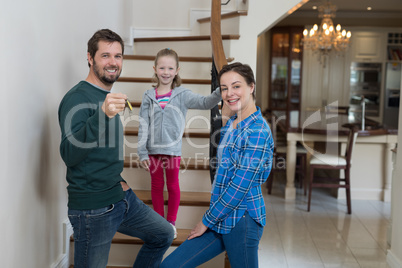 Parents and daughter standing on stairs