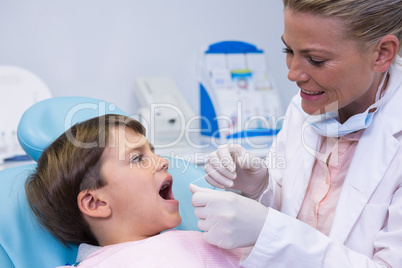 Dentist examining boy at medical clinic