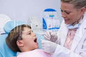 Dentist examining boy at medical clinic