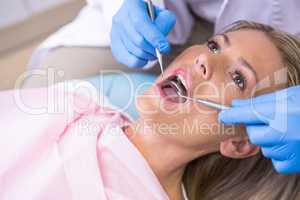 Dentist examining woman at medical clinic
