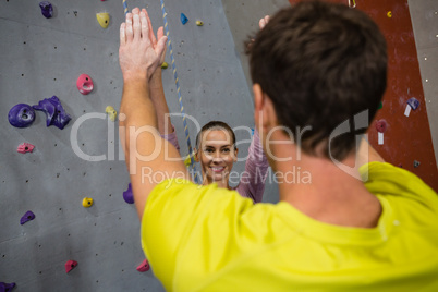 Athletes giving high five in club