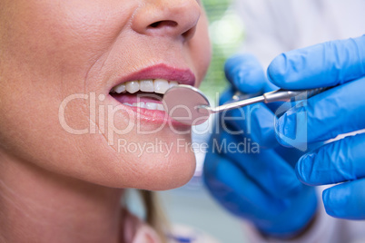 Cropped image of dentist examining woman