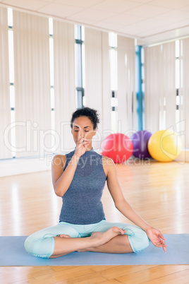 Woman performing yoga in gym