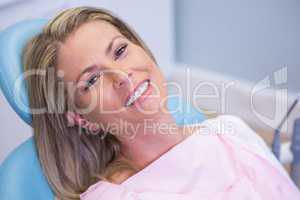 Portrait of smiling patient sitting on dentist chair