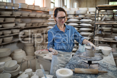 Female potter molding a clay