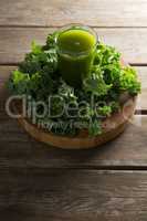 Fresh kale juice in glass on table