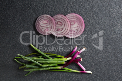 Overhead view of onions with green vegetables